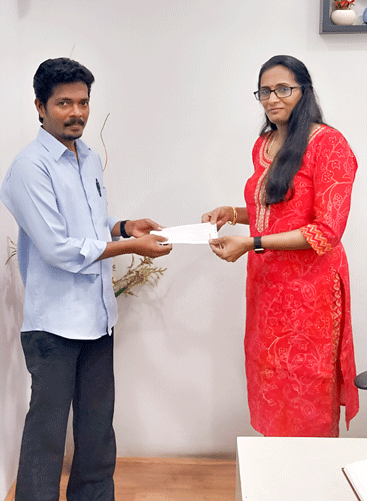 Director Poornalakshmi giving financial aid for student education
